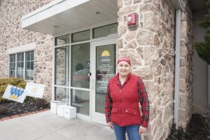 Nilsa, LCH patient, stands in front of the LCH Kennett Square location.