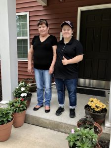 Photo of Juana standing outside with her daughter.