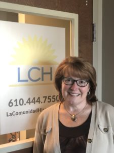 Patient Vanessa stands in front of the office doors to the LCH West Grove location