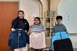 Children receiving warm jackets from the LCH Coats for Kids program.