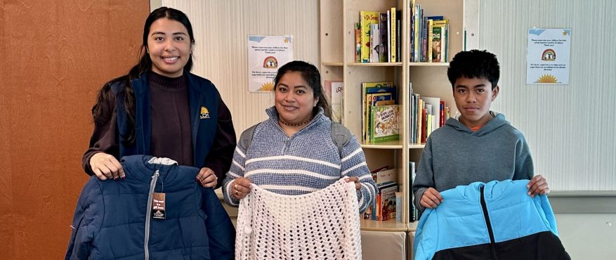 Children receiving warm jackets from the LCH Coats for Kids program.