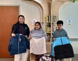 Children receiving warm jackets from the LCH Coats for Kids program.